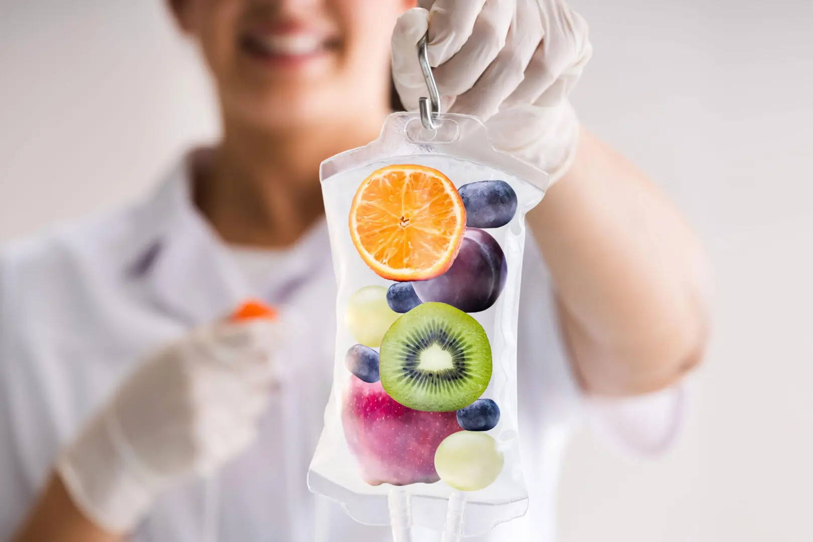 A person holding an iv bag filled with fruit.