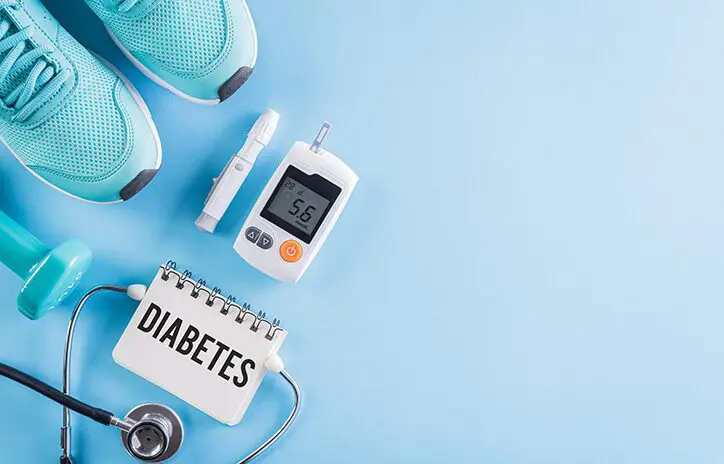 A blue table with a blood glucose meter and some other items.