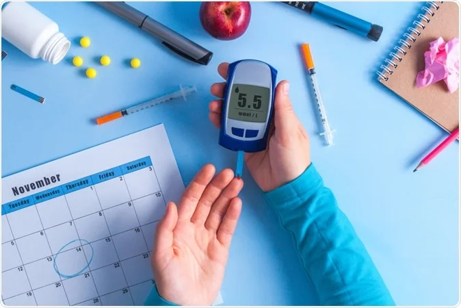 A person is holding a blood glucose meter.