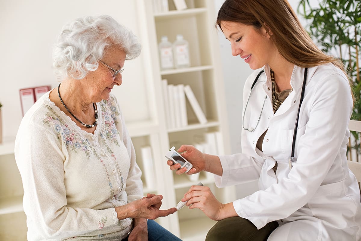 A doctor showing an older woman something on her phone.
